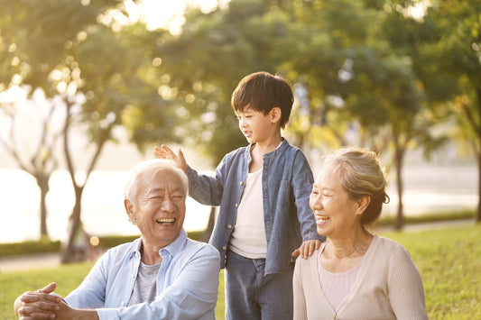 grandparents playing with their grandkid outside keeping him safe