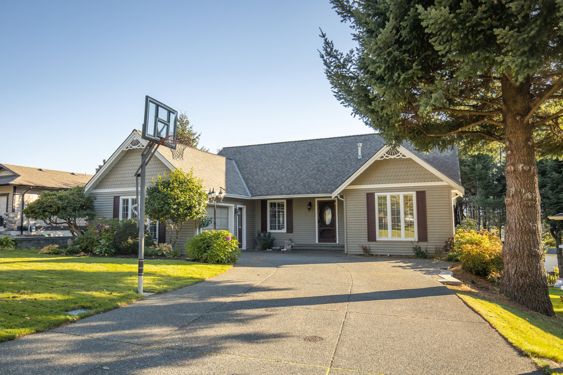 single family home with basketball hoop in driveway