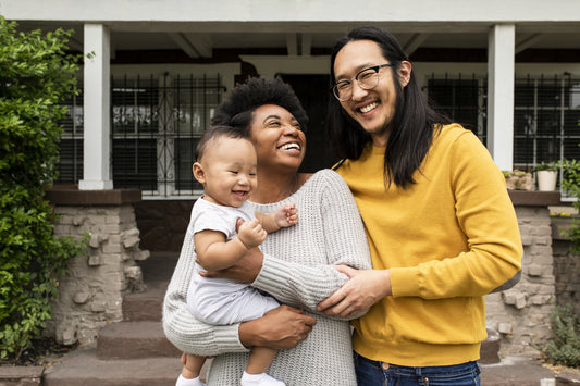 happy family outside their home following home safety tips to avoid common household hazards