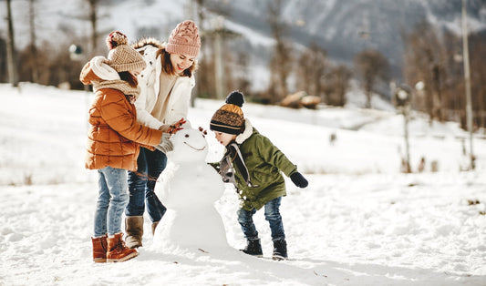 women and children playing in the snow talking about winter safety tips for kids